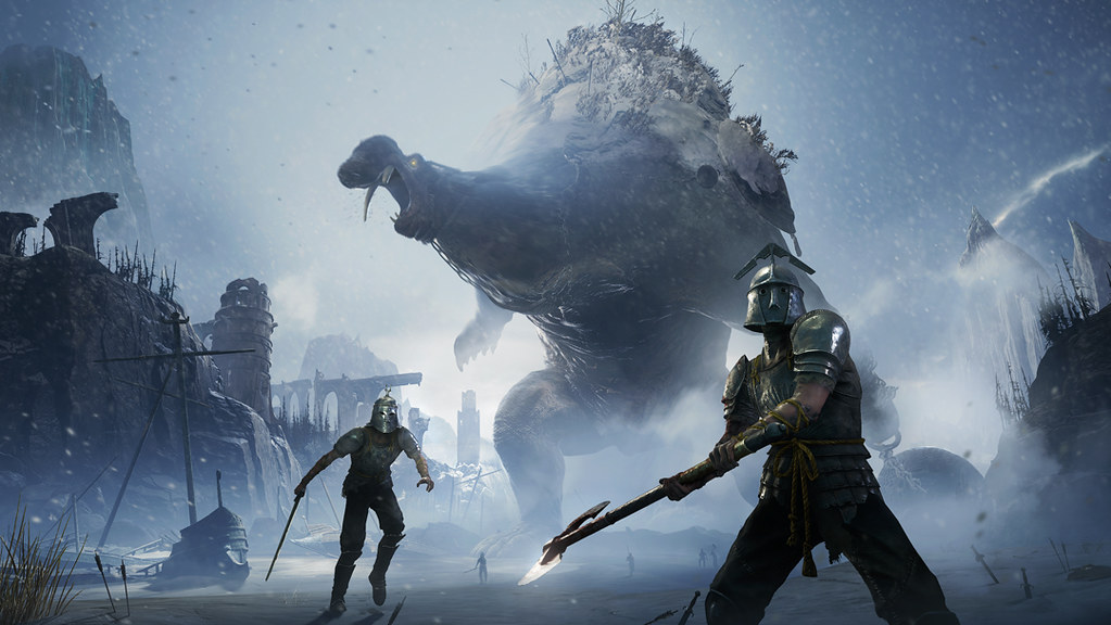 An image of a snowy landscape, filled with ruins and dropped weaponry. In the foreground, several armoured foes raise axes and swords, preparing to strike the player. Towering over them in the background is a behemoth, dragging a huge ball on a chain along side it.